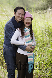 AsiaPix - Man and woman wearing hat and scarves, standing outdoors in nature