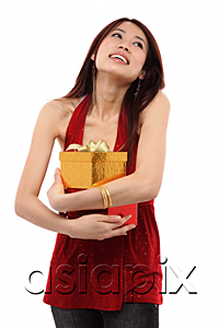 AsiaPix - Young woman holding two presents, looking up