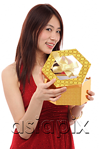 AsiaPix - Young woman opening present, and looking at camera