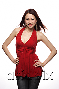 AsiaPix - Young woman smiling at camera, hands on hip
