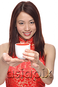 AsiaPix - Young woman wearing cheongsam, holding tea towards camera