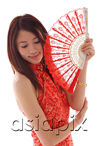 AsiaPix - Young woman wearing cheongsam and holding traditional Chinese fan