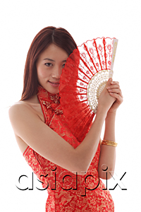 AsiaPix - Young woman wearing cheongsam and holding Chinese fan