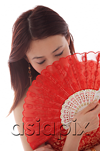 AsiaPix - Young woman holding fan in front of face