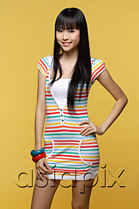AsiaPix - Young woman wearing colorful dress, smiling at camera