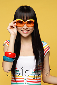 AsiaPix - Young woman wearing big sunglasses, smiling