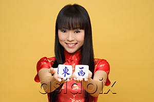 AsiaPix - Young woman holding Chinese dice meaning 