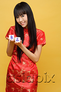 AsiaPix - Young woman holding Chinese dice meaning 