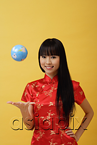 AsiaPix - Young woman wearing red cheongsam and throwing globe in the air
