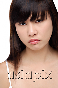 AsiaPix - Young woman frowning, portrait