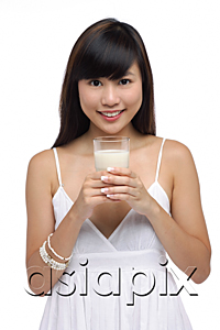 AsiaPix - Young woman holding glass of milk, smiling