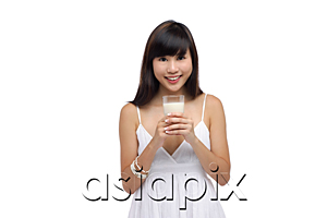 AsiaPix - Young woman wearing white dress and holding glass of milk