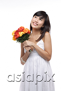 AsiaPix - Young woman wearing white dress and holding bouquet of flowers