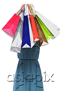 AsiaPix - Young woman holding shopping bags in front of face