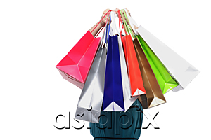 AsiaPix - Young woman holding shopping bags in front of face