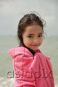 AsiaPix - Young girl on beach wrapped in pink towel
