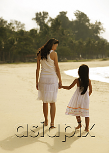 AsiaPix - Mother and daughter walking hand and hand on beach, wearing white dresses