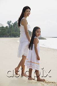 AsiaPix - Mother and daughter standing on beach, wearing white dresses
