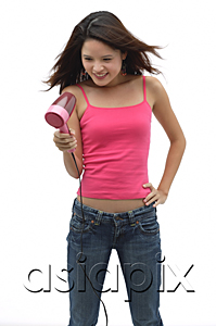AsiaPix - Young woman wearing pink top and blow drying hair