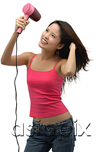 AsiaPix - Young woman blow drying hair and smiling