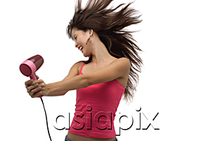 AsiaPix - Young woman blow drying hair with hair flying