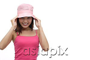 AsiaPix - Young woman wearing pink hat and smiling at camera