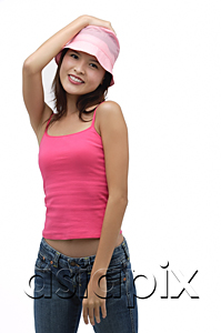 AsiaPix - Young woman wearing pink hat with hand on head, smiling