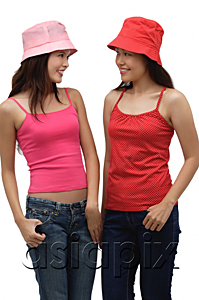 AsiaPix - two young women wearing red and pink, looking at each other