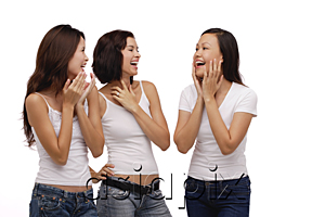 AsiaPix - Three young women standing together and laughing