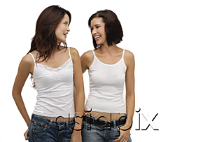 AsiaPix - Two young women standing together and looking at each other
