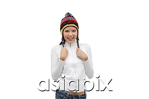 AsiaPix - Young woman wearing winter hat, smiling at camera