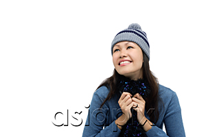 AsiaPix - Young woman wearing winter hat and scarf, smiling
