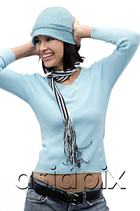 AsiaPix - Young woman wearing hat and scarf, hands on head