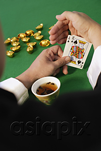AsiaPix - A man playing cards