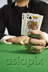 AsiaPix - A man playing cards