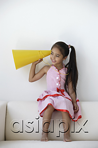 AsiaPix - A young girl plays with a yellow cone
