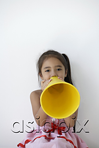 AsiaPix - A young girl plays with a yellow cone