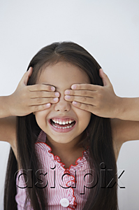 AsiaPix - A young girl covers her eyes with her hands