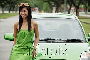AsiaPix - A young woman in a green dress with a green car