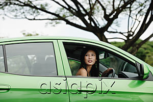 AsiaPix - A young woman drives a green car