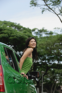 AsiaPix - A young woman leans out of the window of a car