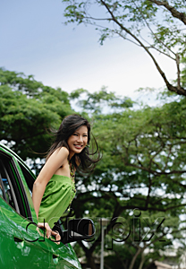 AsiaPix - A young woman leans out of the window of a car