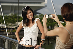 AsiaPix - Friends take photos of each other on a bridge