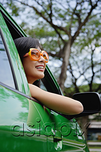 AsiaPix - A young woman drives a green car