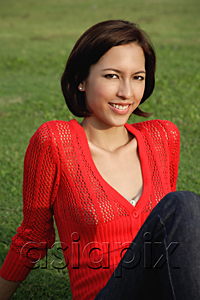 AsiaPix - A woman relaxes on grass