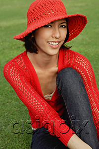 AsiaPix - A woman relaxes on grass