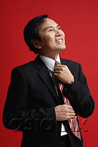 AsiaPix - A businessman adjusts his tie