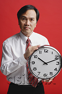 AsiaPix - A man holds a clock