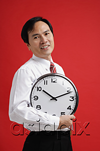 AsiaPix - A man holds a clock