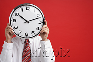 AsiaPix - A man holds a clock in front of his face